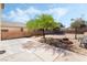 Expansive backyard features a concrete patio, seating area, and mature tree at 8345 Spruce Meadows Ave, Las Vegas, NV 89131