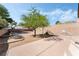 Spacious backyard with a built-in grill, brick border, and lush greenery at 8345 Spruce Meadows Ave, Las Vegas, NV 89131