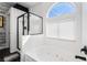 Spa-like bathroom featuring a jacuzzi bathtub, shower, and natural light at 8345 Spruce Meadows Ave, Las Vegas, NV 89131