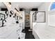 Bright bathroom with double vanity, jacuzzi tub, separate glass shower, and shiplap accent wall at 8345 Spruce Meadows Ave, Las Vegas, NV 89131