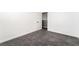 Bedroom features carpet and white walls, with an open door to another room at 8345 Spruce Meadows Ave, Las Vegas, NV 89131