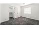 A bedroom with a walk-in closet, carpet, and a window with bright light at 8345 Spruce Meadows Ave, Las Vegas, NV 89131