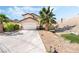 Inviting single-Gathering home featuring a spacious driveway, desert landscaping, and a two-car garage at 8345 Spruce Meadows Ave, Las Vegas, NV 89131