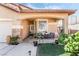 Welcoming front porch with cozy seating, complemented by desert landscaping and a covered entrance at 8345 Spruce Meadows Ave, Las Vegas, NV 89131