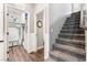 Hallway with open doors to a laundry room and staircase to the second floor, offering convenience and access at 8345 Spruce Meadows Ave, Las Vegas, NV 89131