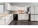 Kitchen with white cabinets, granite countertops, stainless steel appliances, and dark-wood floors at 8345 Spruce Meadows Ave, Las Vegas, NV 89131