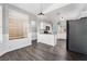Well-lit kitchen with white cabinets, granite countertops, stainless steel appliances, and wood-look flooring at 8345 Spruce Meadows Ave, Las Vegas, NV 89131