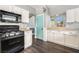 Kitchen featuring stainless steel appliances, white cabinets, granite countertops, and a view to the outside at 8345 Spruce Meadows Ave, Las Vegas, NV 89131