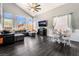 Open-concept living room with vaulted ceilings, large windows, and modern furnishings, creating a bright and airy space at 8345 Spruce Meadows Ave, Las Vegas, NV 89131
