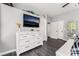 Relaxing main bedroom with TV, dresser, ensuite bathroom and large mirror at 8345 Spruce Meadows Ave, Las Vegas, NV 89131
