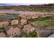 Expansive aerial view of a community featuring houses, a lake, and a golf course at 85 Luce Del Sole # 2, Henderson, NV 89011