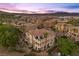 Stunning aerial view of a luxury home with a private balcony and lush landscaping in Lake Las Vegas at 85 Luce Del Sole # 2, Henderson, NV 89011