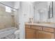 Bathroom features a tiled shower and updated vanity with a decorative mirror at 85 Luce Del Sole # 2, Henderson, NV 89011