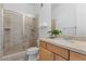 Bathroom featuring a modern shower with glass doors and a vanity with wood cabinets at 85 Luce Del Sole # 2, Henderson, NV 89011