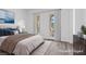 Bedroom with neutral tones and textures, windows, and access to the outdoor spaces at 85 Luce Del Sole # 2, Henderson, NV 89011