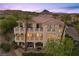 Aerial view of a luxurious multi-story home with balconies and well-maintained landscaping at 85 Luce Del Sole # 2, Henderson, NV 89011