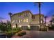 Elegant three-story home features a three-car garage, stone accents, and manicured landscaping at 85 Luce Del Sole # 2, Henderson, NV 89011