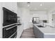 Modern kitchen with white cabinets, stainless steel appliances, and a spacious island with a sink at 85 Luce Del Sole # 2, Henderson, NV 89011