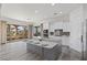 Bright, open kitchen featuring a large island, modern appliances, and access to a scenic balcony at 85 Luce Del Sole # 2, Henderson, NV 89011