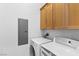 Functional laundry room with modern washer and dryer, complemented by storage cabinets at 85 Luce Del Sole # 2, Henderson, NV 89011