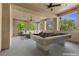 Spacious covered patio with a pool table and comfortable seating, perfect for outdoor entertaining at 85 Luce Del Sole # 2, Henderson, NV 89011