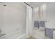 Bright bathroom features tiled shower with white shower curtain and window at 8924 Sail Bay Dr, Las Vegas, NV 89117
