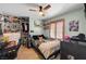 bedroom with a ceiling fan and light, closet, bed with colorful sheets and a shuttered window at 8924 Sail Bay Dr, Las Vegas, NV 89117
