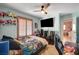 bedroom featuring a ceiling fan, a flat screen TV and a bed with colorful sheets at 8924 Sail Bay Dr, Las Vegas, NV 89117