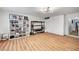 Large bonus room with shelving, laminate wood floors, and a modern lighting fixture plus access to other rooms at 8924 Sail Bay Dr, Las Vegas, NV 89117