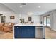 Bright kitchen boasts navy cabinets, white countertops, stainless steel appliances and an island with seating at 8924 Sail Bay Dr, Las Vegas, NV 89117