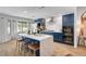 Modern kitchen with blue cabinets, marble countertops, and a large island with seating at 8924 Sail Bay Dr, Las Vegas, NV 89117