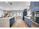 Modern kitchen features custom navy cabinets, quartz countertops, and a suite of stainless steel appliances at 8924 Sail Bay Dr, Las Vegas, NV 89117