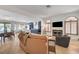 Bright, open living area featuring a fireplace, herringbone floors, and seamless flow into kitchen at 8924 Sail Bay Dr, Las Vegas, NV 89117