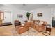 Stylish living room with elegant flooring, a leather sofa, and a view of the entry at 8924 Sail Bay Dr, Las Vegas, NV 89117