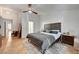 This main bedroom boasts wood floors, ceiling fan, and side table decor at 8924 Sail Bay Dr, Las Vegas, NV 89117