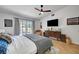 Inviting main bedroom with wood floors, ceiling fan, and sliding glass door at 8924 Sail Bay Dr, Las Vegas, NV 89117