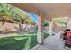 Covered patio area overlooking artificial turf lawn and desert landscaping at 8962 Shale Valley St, Las Vegas, NV 89123