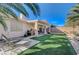 Well-maintained backyard with covered patio, artificial grass, and barbecue area for entertaining at 8962 Shale Valley St, Las Vegas, NV 89123