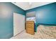 This bedroom features teal walls, wood floors, closet, and a ceiling fan at 8962 Shale Valley St, Las Vegas, NV 89123