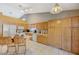 Bright kitchen featuring wood cabinetry, high ceilings and an island with bar stool seating at 8962 Shale Valley St, Las Vegas, NV 89123