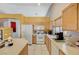 Cozy kitchen featuring white appliances, wood cabinets, and natural light at 8962 Shale Valley St, Las Vegas, NV 89123
