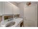 Bright laundry room equipped with front load washer and dryer and white cabinets at 8962 Shale Valley St, Las Vegas, NV 89123