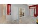 Bright and spacious living room with tile flooring and high ceilings, painted with red accent wall at 8962 Shale Valley St, Las Vegas, NV 89123