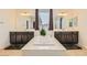 Luxurious bathroom with dual sinks, soaking tub, dark wood cabinets, and tiled floor at 9020 Tiffany Oaks Ave, Las Vegas, NV 89148