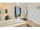 Stylish bathroom featuring soaking tub, glass shower, vanity with modern fixtures and neutral decor at 9020 Tiffany Oaks Ave, Las Vegas, NV 89148