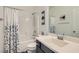 Bright bathroom with shower-tub combo, patterned shower curtain, modern faucet, and decorative accents at 9020 Tiffany Oaks Ave, Las Vegas, NV 89148