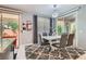 Modern dining area featuring a sleek table, stylish chairs, and sliding glass doors to the patio at 9020 Tiffany Oaks Ave, Las Vegas, NV 89148