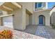 Inviting home entrance with a blue arched front door, a paved walkway, and lush landscaping at 9020 Tiffany Oaks Ave, Las Vegas, NV 89148