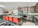 Modern kitchen boasts stainless appliances, gray cabinets, granite countertops, and island with seating at 9020 Tiffany Oaks Ave, Las Vegas, NV 89148
