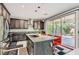 Modern kitchen with a large island, granite countertops, stainless steel appliances, and ample cabinet space at 9020 Tiffany Oaks Ave, Las Vegas, NV 89148
